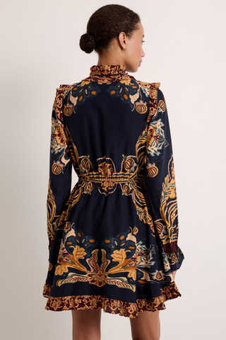 Thalia Dress in Lasso featuring a navy Western-inspired print, long sleeves, ruffle detailing, and a handkerchief mini hem.