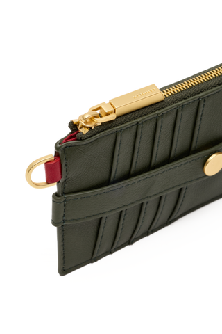 Hammitt 210 East Wallet in Twin Crest Pebble featuring deep forest green pebbled leather, curved edges, card slots, and brushed gold hardware.