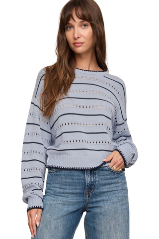 Model wearing the Z Supply Darby Stripe Sweater in Skyline featuring pointelle knit detailing, long sleeves, and striped design.