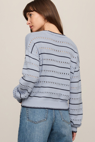 Model wearing the Z Supply Darby Stripe Sweater in Skyline featuring pointelle knit detailing, long sleeves, and striped design.