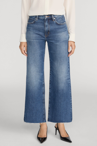FRAME The Swing jeans in Lucky Raw After featuring a medium blue wash, high rise, cropped wide-leg silhouette, and raw hem.