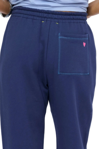 Kerri Rosenthal Weekend Barb Sweatpant in indigo blue featuring a wide-leg silhouette, elastic waistband, and embroidered heart detail.