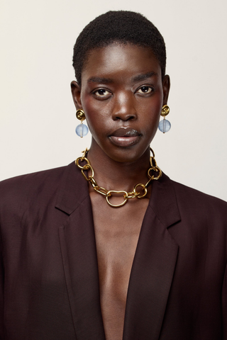 Lizzie Fortunato Luminary Earrings in Purple featuring gold-plated brass spiral studs and hanging lilac resin bead drops.