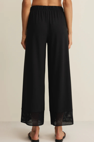 Z Supply Banyan Crochet Pant in Black featuring a relaxed straight-leg silhouette, elastic waistband, and crochet lace trim at the hem