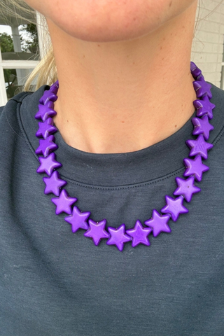 Smith & Co. Design Large Star Necklace in Purple featuring oversized vibrant purple star-shaped beads and a lobster clasp closure.