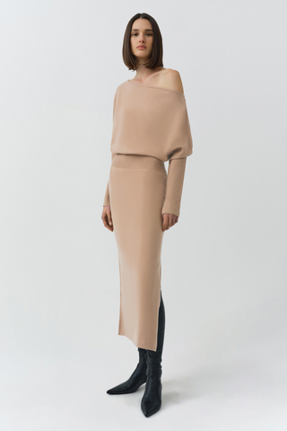 SIMKHAI Janese Off Shoulder Midi Dress in Camel featuring a wide off-the-shoulder neckline, fitted waist, and straight midi skirt.