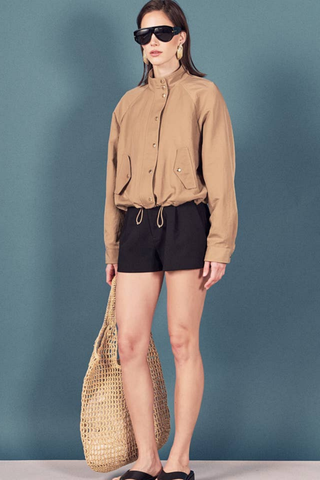 English Factory Lightweight Bomber Jacket in beige with long sleeves, front pockets, and an adjustable drawstring hem.