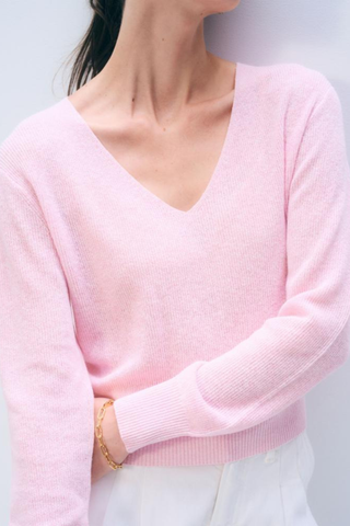 Light pink long sleeve V-neck sweater in a soft knit fabric