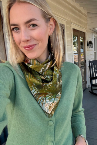 Swells Charleston Marsh silk scarf featuring a painted Lowcountry marsh landscape with palmettos, waterways, and soft green tones