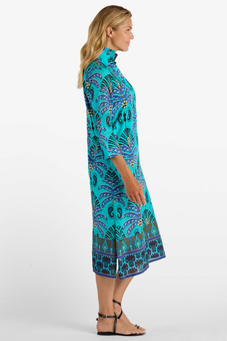 Model wearing the Jude Connally Kallan Dress in Peacock Garden Black featuring a colorful Peacock Garden print and midi silhouette.