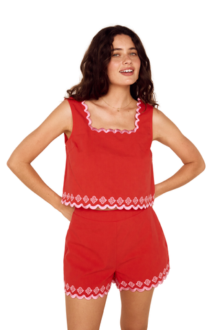 Model wearing the MINKPINK Amaya Embroidered Top in Coral/Pink featuring embroidered scalloped trim, a square neckline, and a relaxed sleeveless silhouette.