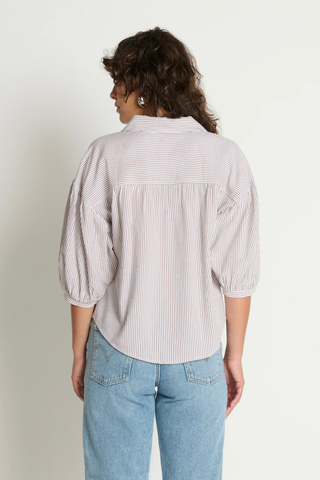 Model wearing the Nation LTD Jaynee Blouse in Praline Stripe, a lightweight striped button-front blouse featuring a relaxed fit, classic collar, three-quarter sleeves, and a breezy textured woven fabric.