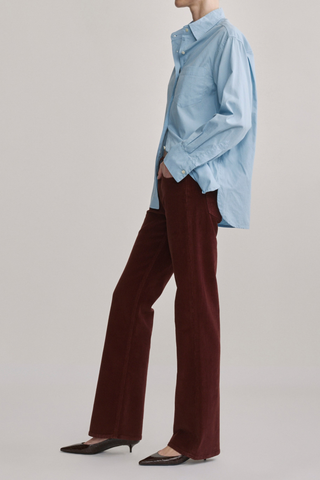 DL1961 Bella Slim Boot Jean in Syrah Cord featuring a mid-rise slim bootcut silhouette in muted red corduroy.