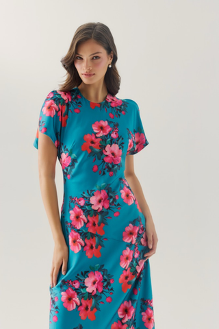 Hutch Rosalee Dress in Emerald/Pink featuring a vibrant emerald green background, bold pink floral print, high neckline, short sleeves, and flowing maxi silhouette.