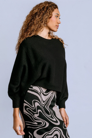 Kerisma Echo Sweater in Black featuring an oversized crew neckline, relaxed dolman sleeves, and soft marled knit texture.