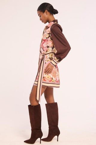 Misa Poppy Dress in In Full Bloom, a chocolate brown floral satin mini shirtdress with long sleeves, contrast trim, and a tie waist.
