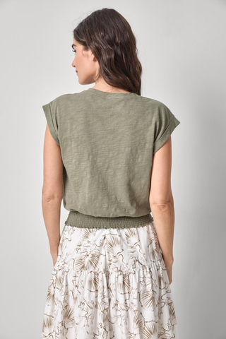 Model wearing the Lilla P Smocked Hem V-Neck Tee in Fern featuring a relaxed blouson fit, V-neckline, extended shoulders, and smocked elastic hem.