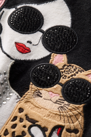 Alice + Olivia Gleeson Staceface Leopard Pullover in soft white with black trim, embellished Staceface graphic, and leopard print details.