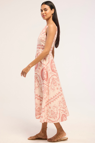 Model wearing the Misa Amity Dress in Terra Ceramic featuring a sleeveless fitted bodice, high neckline, Terra Ceramic print, and box-pleated midi skirt.