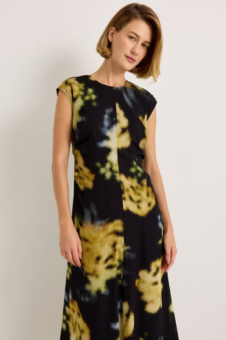 Marie Oliver Zuri Dress in Lush featuring oversized golden florals on a black background with a fluid sleeveless maxi silhouette.