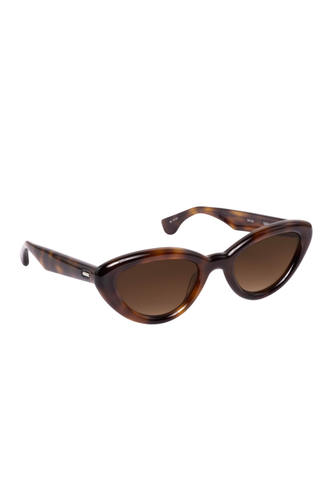 Krewe Sasha Sunglasses in Maple featuring a glossy brown cat-eye acetate frame and amber gradient lenses.