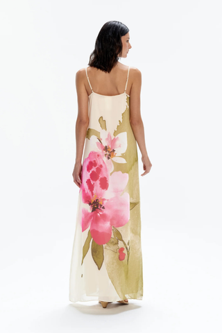White maxi dress with green and pink tropical floral print and spaghetti straps by Especia worn with sandals