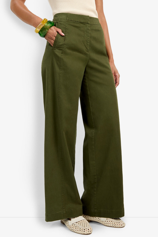 Person wearing olive green pants on a white background