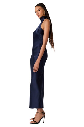 Steve Madden Lara Dress in Deep Blue, a sleeveless navy maxi dress with a high neckline, open back, and statement back tie.