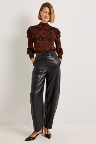 Roxi Top in Oxide featuring a rust and black abstract print, fitted turtleneck silhouette, and pleated puff sleeves.