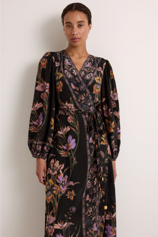 Marie Oliver Everette Dress in Nightshade featuring a dark floral placement print, wrap silhouette, long puff sleeves, and maxi length.