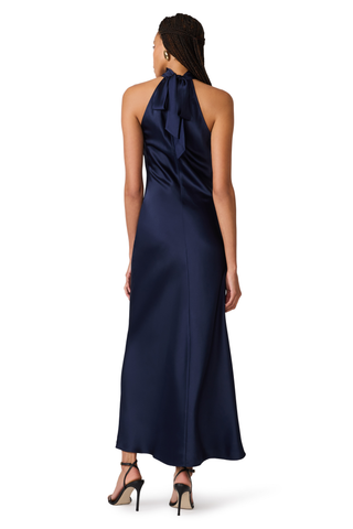 Steve Madden Lara Dress in Deep Blue, a sleeveless navy maxi dress with a high neckline, open back, and statement back tie.