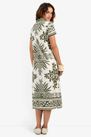 Woman wearing a patterned dress on a white background