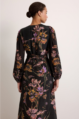 Marie Oliver Everette Dress in Nightshade featuring a dark floral placement print, wrap silhouette, long puff sleeves, and maxi length.