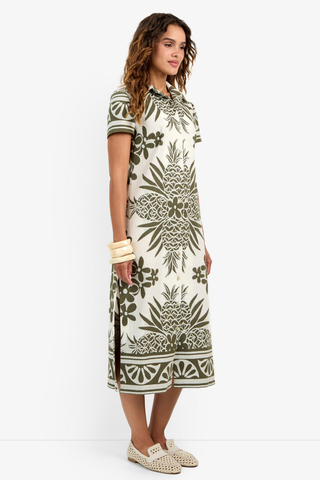Woman wearing a patterned dress on a white background
