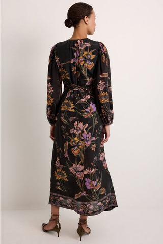 Marie Oliver Everette Dress in Nightshade featuring a dark floral placement print, wrap silhouette, long puff sleeves, and maxi length.