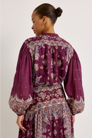 Rhiannon Top in Majesty featuring a rich purple paisley print, stand collar, button front, and full gathered long sleeves.