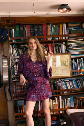 Olivia by Livro Effie Top in Alpine Sprigs featuring a burgundy, pink, and blue geometric floral print, deep V-neckline, and long sleeves.