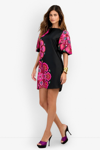 Trina Turk Luv Dress in Multi featuring a black mini silhouette with oversized pink floral print, boat neckline, and short bubble sleeves.