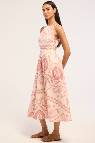 Model wearing the Misa Amity Dress in Terra Ceramic featuring a sleeveless fitted bodice, high neckline, Terra Ceramic print, and box-pleated midi skirt.