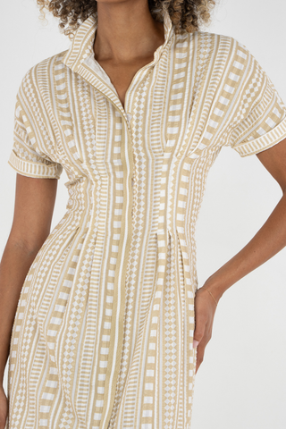 Woman wearing a patterned dress on a white background