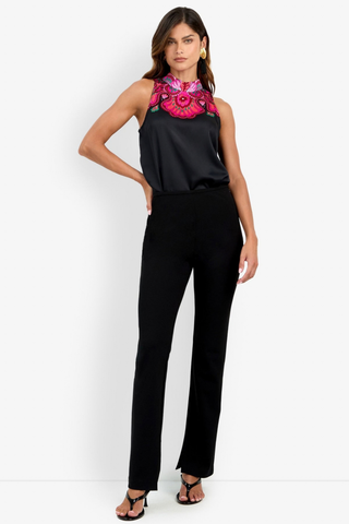 Trina Turk Milena Pant in black featuring a slim-leg silhouette, flat front, side zip closure, and subtle inner hem slits.