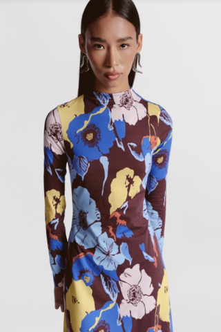 De Loreta Mandy Dress featuring a colorful oversized floral print, long sleeves, high neckline, and maxi silhouette.