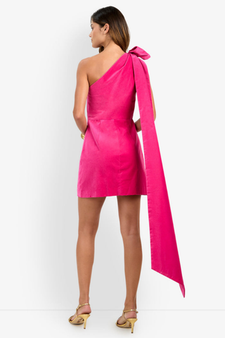 Trina Turk Romance 2 Dress in Tormalina pink featuring a one-shoulder neckline, oversized bow with cascading train, and a fitted velveteen mini silhouette.