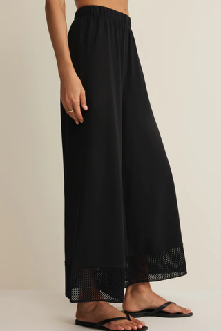 Z Supply Banyan Crochet Pant in Black featuring a relaxed straight-leg silhouette, elastic waistband, and crochet lace trim at the hem