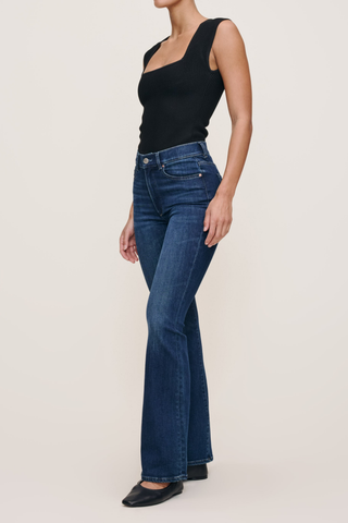Model wearing the DL1961 Bridget Boot Jean in Sea Front with a high-rise bootcut silhouette.