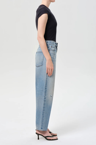 Model wearing AGOLDE The 80’s Jean in Orbital, a high-rise straight-leg rigid denim jean in a medium vintage indigo wash