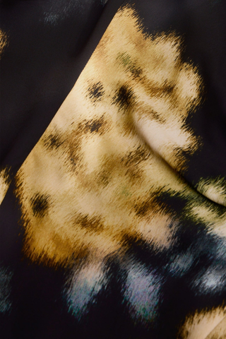 Marie Oliver Zuri Dress in Lush featuring oversized golden florals on a black background with a fluid sleeveless maxi silhouette.