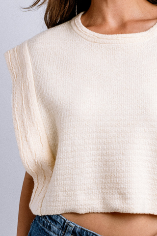 Model wearing the Kerisma Imogen Top in French Vanilla featuring textured knit fabric and extended shoulders.