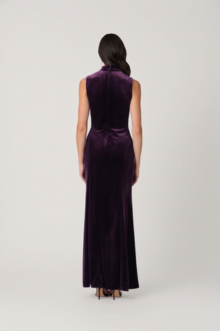 Shoshanna Lorelei Dress in Dark Plum featuring stretch velvet, a high mock neckline, pleated shoulder detail, and floor-length fit-and-flare silhouette.