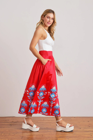 Sheridan French Lillian Skirt in Red Thistle featuring vibrant red print, maxi silhouette, smocked waistband, and colorful border detailing